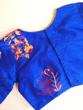 Red organza saree with a contrast blue work blouse
