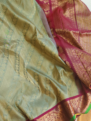 A Royal Gadwal kanchi saree in sage green with rich magenta border