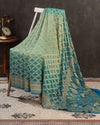 A Bandini Georgette saree in hues of blue paired with a blue pearl work blouse