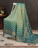 A Bandini Georgette saree in hues of blue paired with a blue pearl work blouse