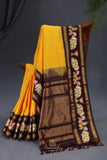 Yellow Gadwal Pattu saree with brown border and tanjore painting