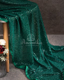 Dark bottle Green georgette sequins saree paired with a stunning blouse and belt