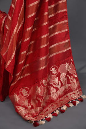 A striking red Mashru silk saree with a designer blouse