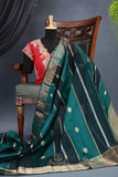 A lovely organza saree in shaded dark green with a red designer blouse