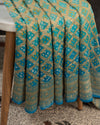 A Bandini Georgette saree in hues of blue paired with a blue pearl work blouse