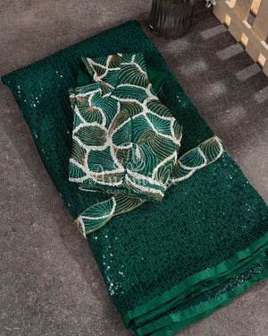 Dark bottle Green georgette sequins saree paired with a stunning blouse and belt