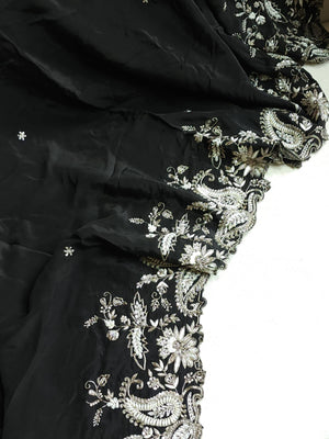 A pure crepe saree in black with stunning silver embroidered border