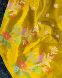 Mustard yellow organza saree with a contrast orange blouse