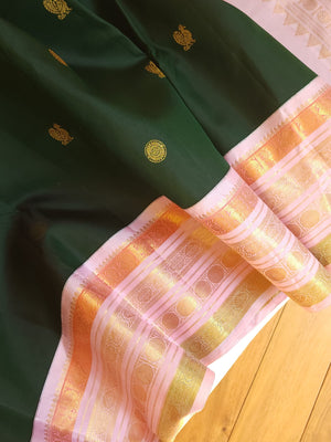 Kanjeevaram saree in bottle green with a baby pink border