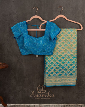 A Bandini Georgette saree in hues of blue paired with a blue pearl work blouse