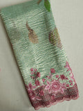 Crush tissue saree in aqua green with floral cutwork border