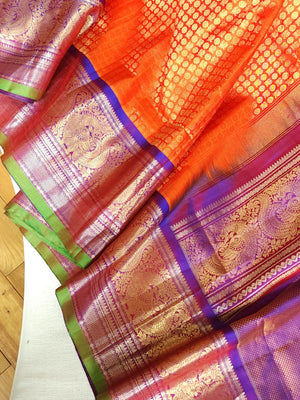 A grand Gadwal Kanchi saree in orange for your joyous occasions