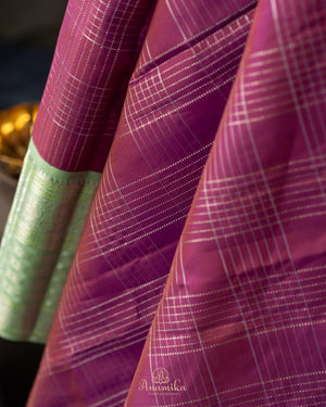 A kanjeevaram saree in purple with pastel green combo