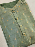 A tissue silk kurta in sage green with Zari woven buttas