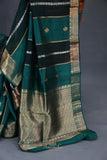 A lovely organza saree in shaded dark green with a red designer blouse