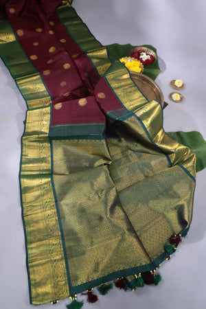 An exquisite kanjeevaram saree in deep maroon and emerald green combo