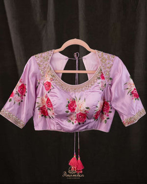 A beautiful Floral blouse in pastel pink with intricately designed embroidery