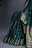 A lovely organza saree in shaded dark green with a red designer blouse