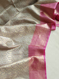 Kanjeevaram in a beautiful shade of gray with a contrast pink border.
