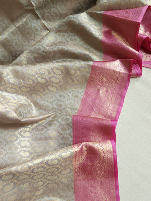 Kanjeevaram in a beautiful shade of gray with a contrast pink border.