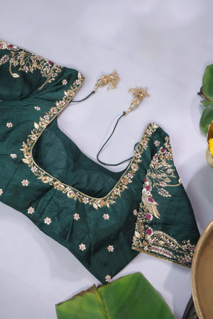 An exquisite kanjeevaram saree in deep maroon and emerald green combo