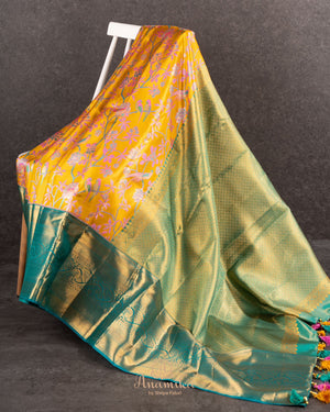 A meenakari kanjeevaram saree in yellow and teal