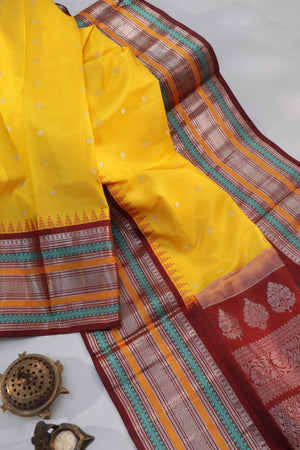 Radiant yellow Kanchipattu saree with maroon border