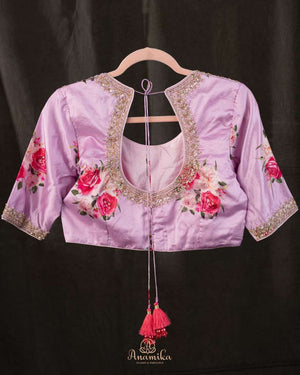 A beautiful Floral blouse in pastel pink with intricately designed embroidery