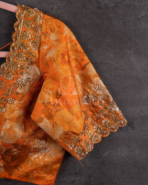 Crushed Tissue Saree in peach paired with a floral work blouse