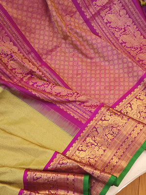 Royal Gadwal kanchiPattu saree in a beautiful parrot green and magenta combination