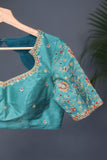 A classic patola in aqua blue with a striking contrast red