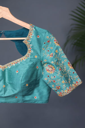 A classic patola in aqua blue with a striking contrast red