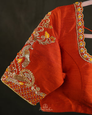 Kanchi soft silk saree in yellow paired with a contrast orange blouse