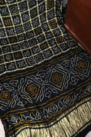 Black Bandini Gharchola saree with a showstopper blouse patter