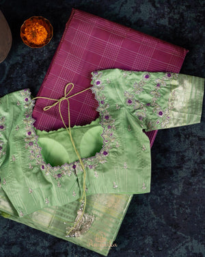 A kanjeevaram saree in purple with pastel green combo