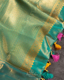 A meenakari kanjeevaram saree in yellow and teal