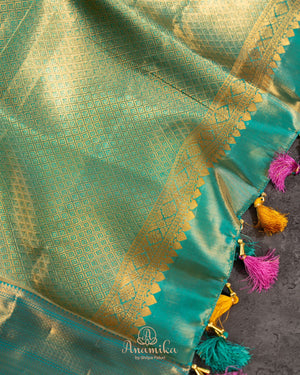 A meenakari kanjeevaram saree in yellow and teal