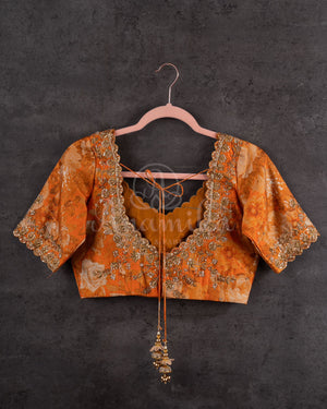 Crushed Tissue Saree in peach paired with a floral work blouse