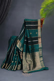 A lovely organza saree in shaded dark green with a red designer blouse