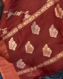 Rust Organza saree paired with a floral blouse