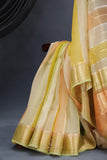 A lovely organza saree in shaded yellow with a dark blue designer blouse