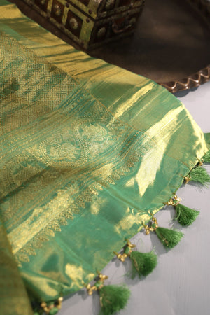 Green Tissue Kanchi saree with a contrast off white blouse