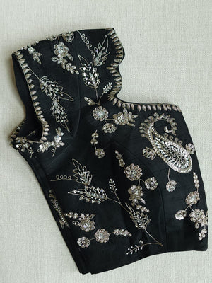 A pure crepe saree in black with stunning silver embroidered border
