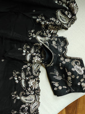 A pure crepe saree in black with stunning silver embroidered border