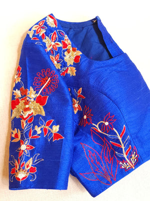Red organza saree with a contrast blue work blouse