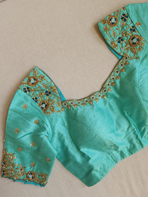 Peacock Green with aqua blue rawsilk saree with a stylish blouse