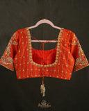 Kanchi soft silk saree in yellow paired with a contrast orange blouse