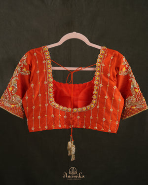 Kanchi soft silk saree in yellow paired with a contrast orange blouse