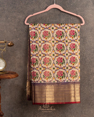 Light brown twill Patola saree with a contrast lavender border