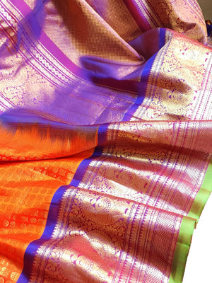 A grand Gadwal Kanchi saree in orange for your joyous occasions